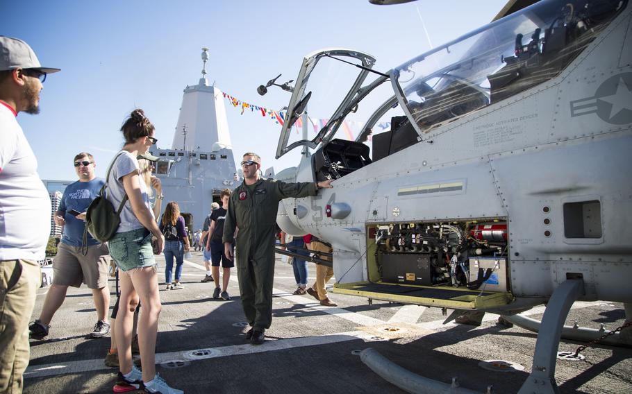 U.S. Marine Corps Capt. Joe Porzio, an AH-1Z Viper pilot with Marine Light Attack Helicopter Squadron 469, interacts with community members during Fleet Week San Diego 2019 aboard the San Antonio-class amphibious transport dock USS San Diego, in San Diego, Nov. 9, 2019. 