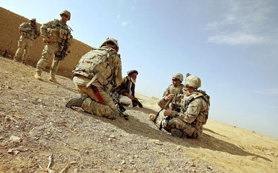 Soldiers with Company A, 2nd Battalion, 2nd Infantry Regiment talk with an elder in the village of Mama Karez.