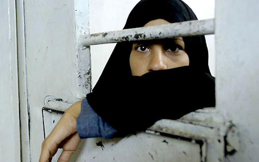 Iraqi prisoner Nidal Dadr, 17, awaits the outcome of her case in the Karbala jail after being arrested for kissing her husband in public. Her crime isn&#39;t a violation of new Iraq laws, but because she was arrested by Iraqi police her case must go before a judge before it can be dismissed.