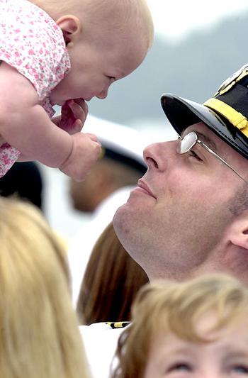 USS Cowpens Chief Engineer Lt. Cmdr. Vincent Perry greets his daughter Grace after the ship&#39;s May 6 return to Yokosuka from the Persian Gulf.