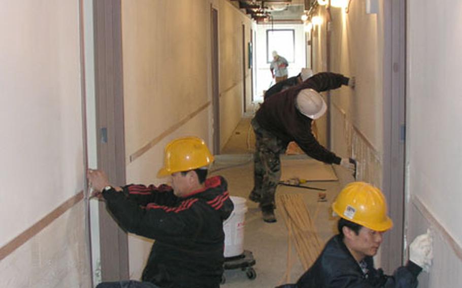 At Osan Air Base, South Korea, workers are busy on the interior of a four-story officers&#39; dorm set to open this summer. The $8.6 million project includes the 69-room dorm plus parking spaces and landscaping.