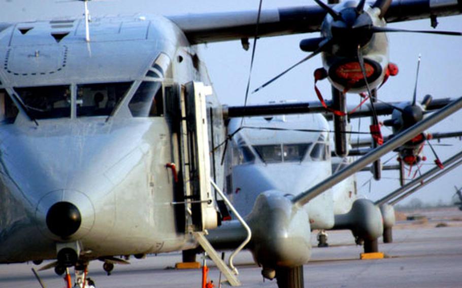 Boxy and utilitarian C-23 Sherpas at Balad air base wait to carry cargo and people to airstrips around Iraq.