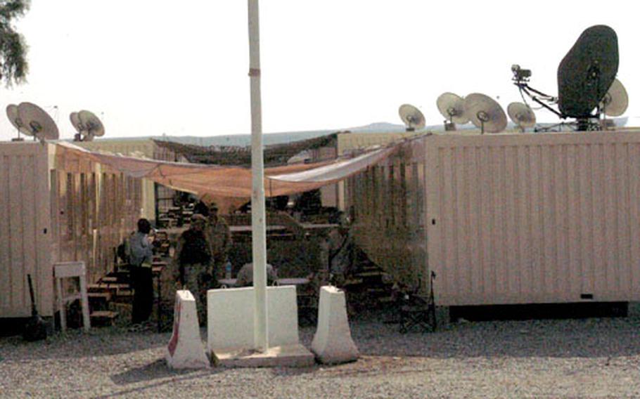 Satellite dishes jam the tops of living trailers at FOB Marez in Mosul, Iraq. Except the large dish on the right, all are personal, commercial systems.