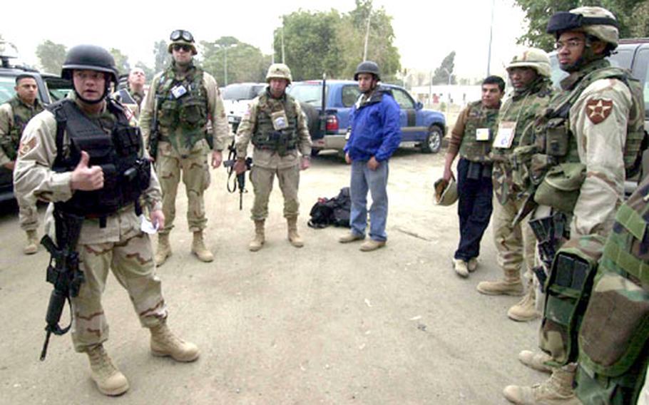 Staff Sgt. Scott Ramsey from Washington, D.C., conducts a security briefing before escorting the U.S. military lawyers working with the Central Criminal Court of Iraq in Baghdad.