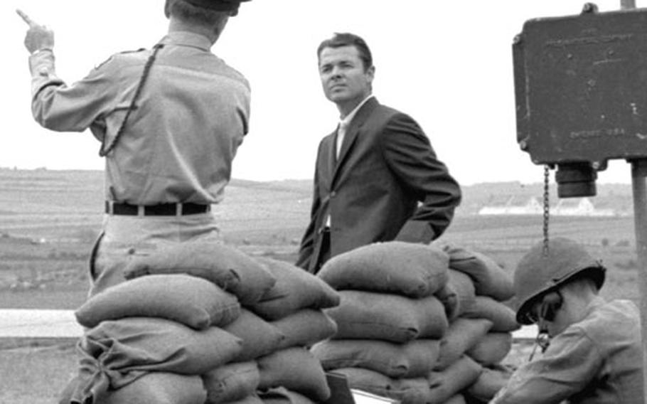 Audie Murphy gets some instructions on the set at Würzburg.