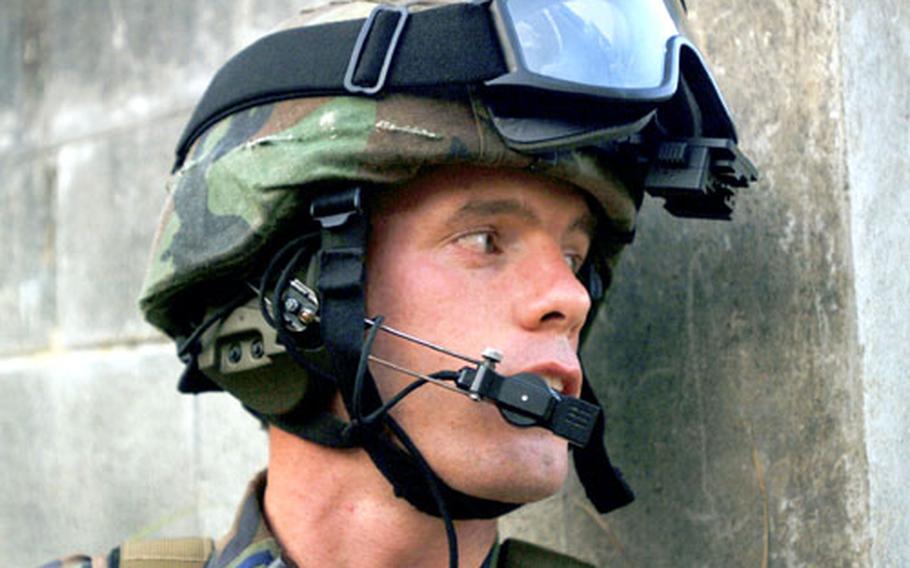 Capt. Charles Bris-Bois, a combat rescue officer from the 31st Rescue Squadron, Kadena Air Base, Japan, keeps an eye on “enemy forces” during a non-combatant evacuation exercise at Combat Town training area, Okinawa, Japan. He was taking part in Joint Air and Sea Exercise 2005.