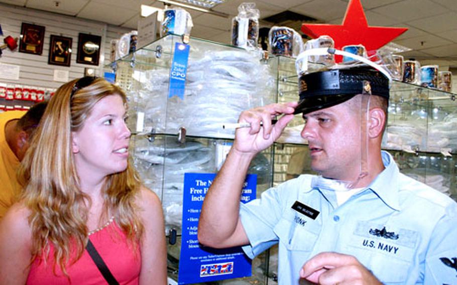 Petty Officer 1st Class Joe Pionk brought his wife, Liz, with him to pick out uniforms and accessories he will need after he is promoted officially to chief petty officer in September.