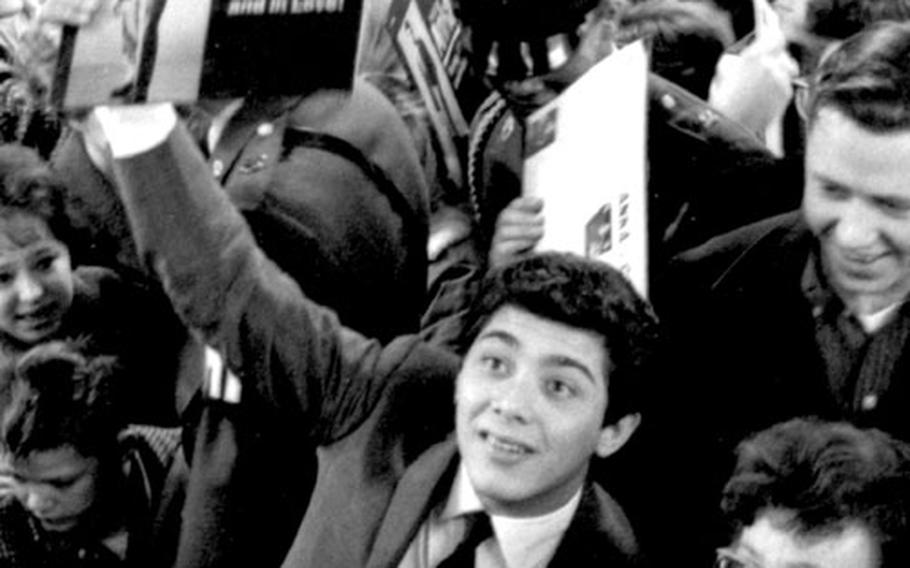 Singer Paul Anka holds up one of his albums at the Frankfurt post exchange in March, 1962.