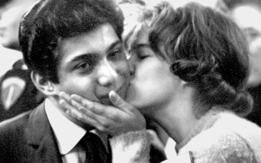Singer Paul Anka gets a kiss from a fan at the Frankfurt post exchange in March, 1962.