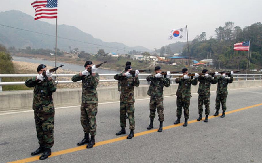 U.S. soldiers fire a salute on the during the dedication ceremony.