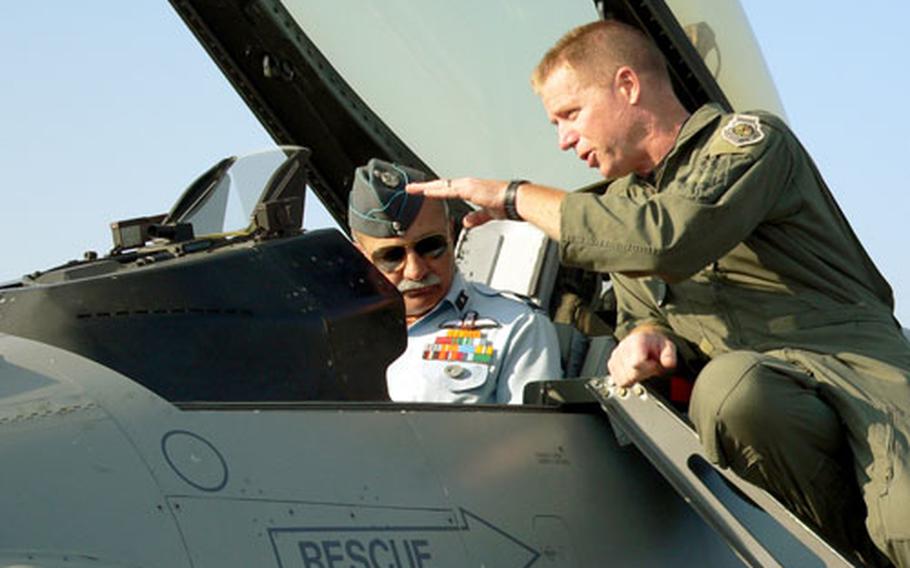 Indian air force General B.C. Nanjapa gets a bird’s-eye view sitting in the cockpit of an F-16 at Kalaikunda Air Station, India, as he and Col. Rusty Cabot, U.S. deployed forces commander, discuss the capabilities of the F-16.