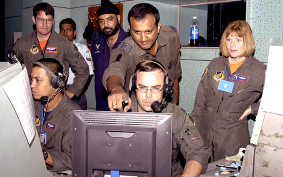 Capt. Michael Thomas, lower center, senior director, and Tech. Sgt. Steven Harshman, lead weapons director, with the 961st Airborne Air Control Squadron from Kadena Air Base, Okinawa, monitor and direct aircraft with an Indian Air Force squadron leader recently during Cope India ’06.