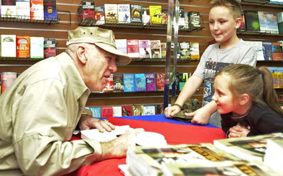 R. Lee Ermey chats with Mackenzie and Dylan Grow as he signs a copy of his book, “Mail Call,” for them at the Camp Foster Bookmark in January, 2006. Ermey held three book signings at Camp Hansen, Kadena Air Base and Camp Foster.