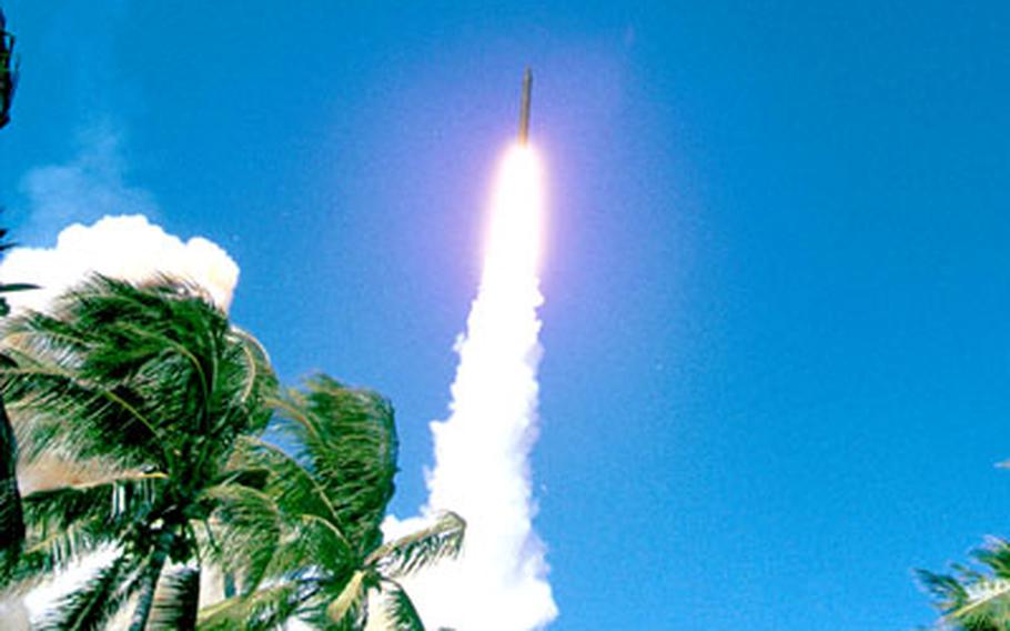 An interceptor missile rockets into the sky in a test launch.