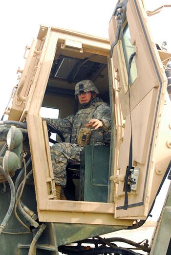 Sgt. David Turner of the 15th Engineer Company sits at the controls of a bucket loader.