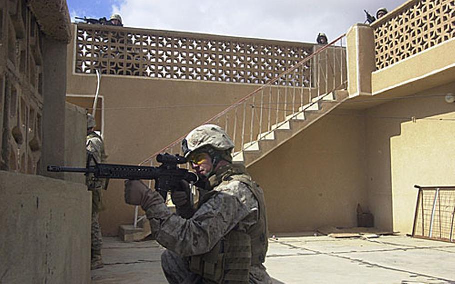 Lance Cpl. Benjamin Ford and fellow Marines with Company E, 2nd Battalion, 3rd Marine Regiment, scan Haditha from a rooftop Wednesday afternoon moments after an insurgent shot at the men. The Marines and Iraqi Police were participating in the two-day Operation Backbreaker II in which the forces detained 19 suspects.