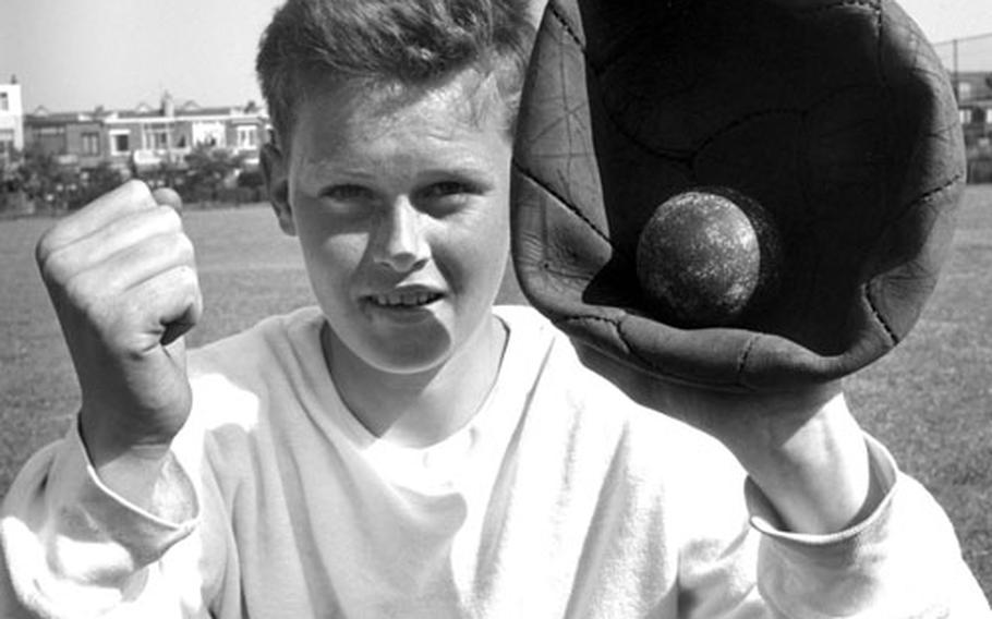 An old soccer ball serves as a catcher’s mitt for a baseball player in the Netherlands in 1961.