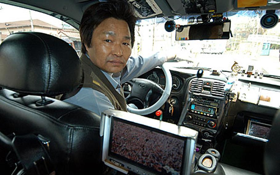 Cho Young-ho, a South Korean taxi driver in Seoul, shows off his custom taxi.