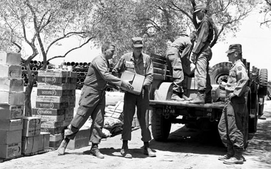 Sfc. Robert Chinn supervises the loading and unloading of rations.
