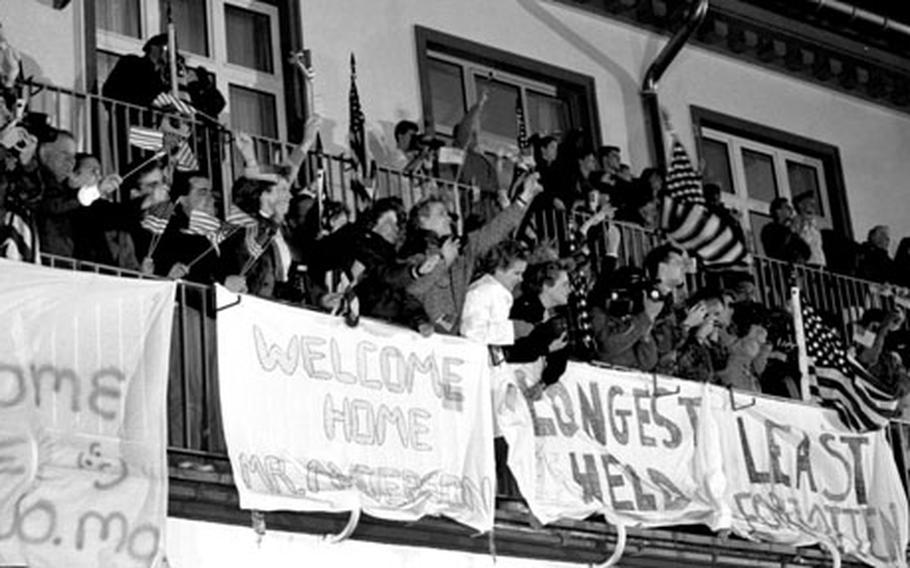 Well-wishers on the balcony at the Air Force hospital at Wiesbaden welcome Terry Anderson back to U.S. soil.