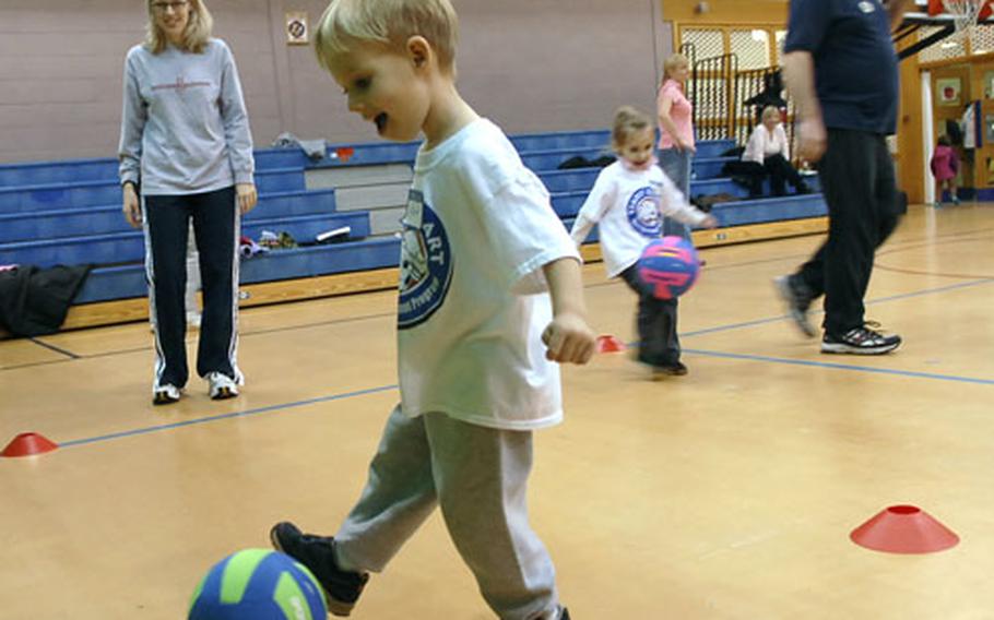Brandon Svoboda, 3, maneuvers through a soccer course during the Smart Start program at RAF Mildenhall with the help of his mom, Teresa Svaboda, who looks on, Feb. 20, 2008. Due to the effects of sequestration, the military said in 2013 that youth sports on bases could be cut or reduced.