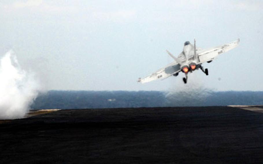 A jet takes off from the U.S.S. Nimitz.
