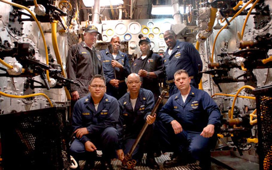 The boiler technicians of the USS Kitty Hawk might be the last sailors to tend such conventional steam-powered systems. Top, left to right, are Chief Petty Officer Billy Grogan, Master Chief Petty Officer Joseph Richardson, Lt. j.g. Mitch Miller, Master Chief Petty Officer Michael Gwinn; bottom row from left to right, Chief Petty Officer Joey Ullegue, Chief Petty Officer David Ford and Chief Petty Officer Douglas Welch.