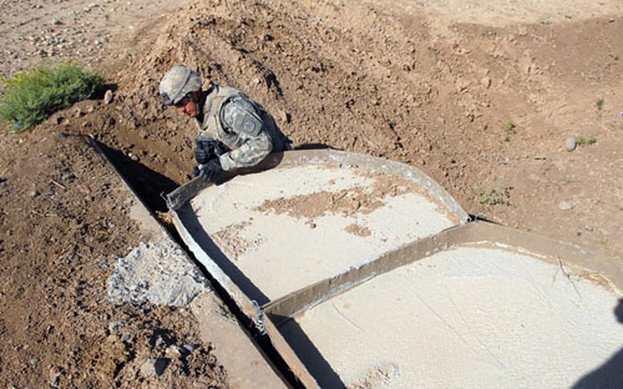 First Lt. Matthew Felumlee, a platoon leader in Apache Troop, 1st Squadron, 3rd Armored Cavalry Regiment, checks a culvert Tuesday in rural Ninevah province.
