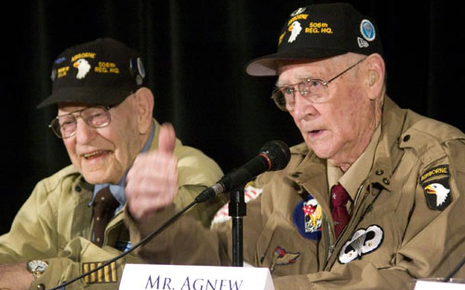 Jake McNiece, left, enjoys the story being told by fellow "Filthy Thirteen" paratrooper Jack Agnew during the American Veterans Center&#39;s 2008 annual conference in Washington, D.C.