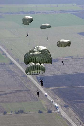 U.S. and Bulgarian paratroopers float to the ground over southeastern Bulgaria last week during Operation Thracian Spring 2009. In its third year, the exercise gives the U.S. and Bulgarian military opportunity to interact and train together. U.S. and Bulgarian paratroopers performed daytime and nighttime jumps during the exercise, getting a chance to use each other’s aircraft and share techniques.