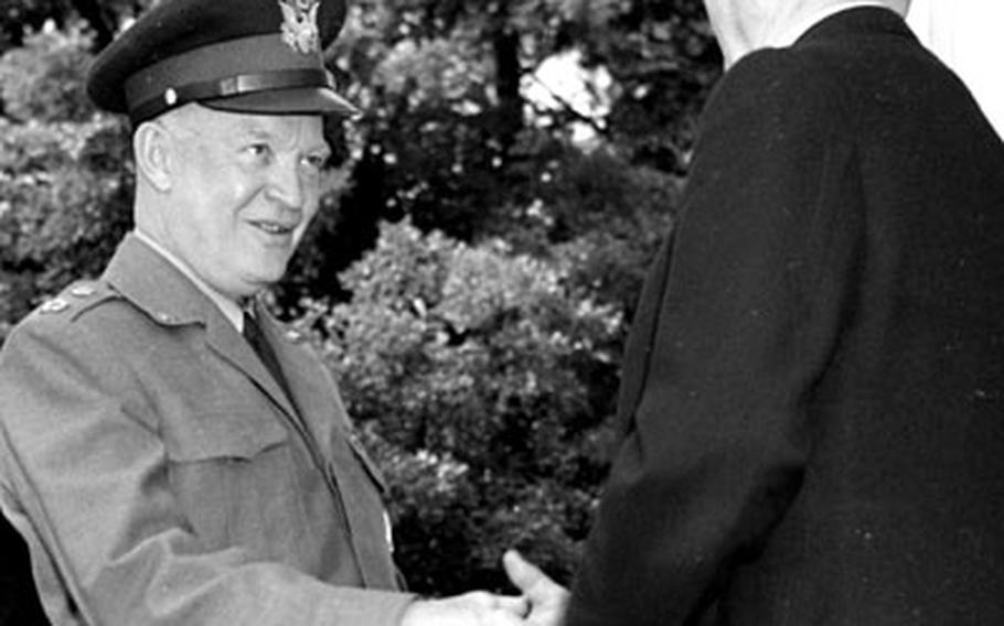 Chancellor Adenauer greets Gen. Eisenhower.
