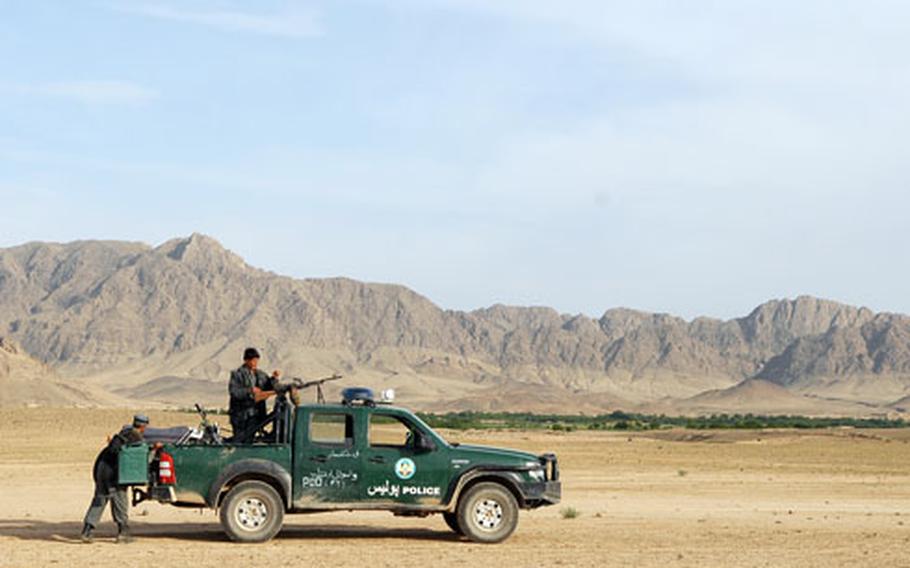 Afghan National Police load a motorcycle into the bed of a Ford Ranger patrol truck on Saturday in the Arghandab district of southern Afghanistan. The following day, the truck couldn’t be used because a wheel appeared to be coming off due to the rough terrain.