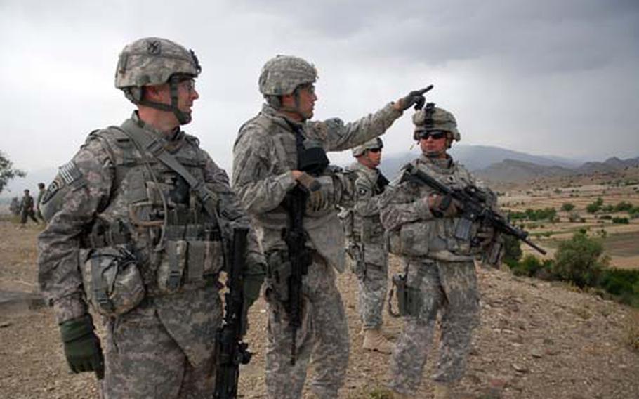 Lt. Col. Pete Molin, center, who commands training teams at Camp Clark in eastern Afghanistan, points to what he called hostile area north of the village of Shembowat on June 14, after a rocket was fired from the area toward Camp Clark, just a few miles away. With him are (left) Lt. Col. Matthew Smith, of the 1st Battalion, 121st Infantry Regiment, of the Georgia National Guard’s 48th Brigade Combat Team, and (right) Molin’s upcoming replacement, Lt. Col. Gary Thurman, also of the Georgia National Guard’s 48th BCT.