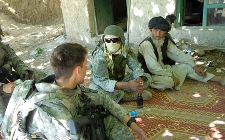 First Lt. Nick D’La Rotta, leader of 3rd Platoon, Company D of the 4th Brigade, 25th Infantry Regiment out of Alaska, talks with a resident of the mountainside village of Chirmir in eastern Khost province on June 16.