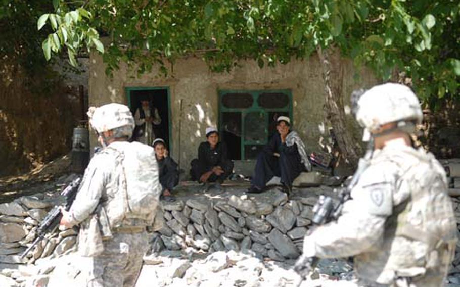 Coalition forces with 3rd Platoon, Company D of the 4th Brigade, 25th Infantry Regiment out of Alaska approach a house on the mountainside village of Chirmir during a mission on June 16. The platoon pushed northward up the wadi past Shembowat into what is perceived as hostile territory in order to make contact and speak to villagers about polling locations ahead of the August presidential elections.