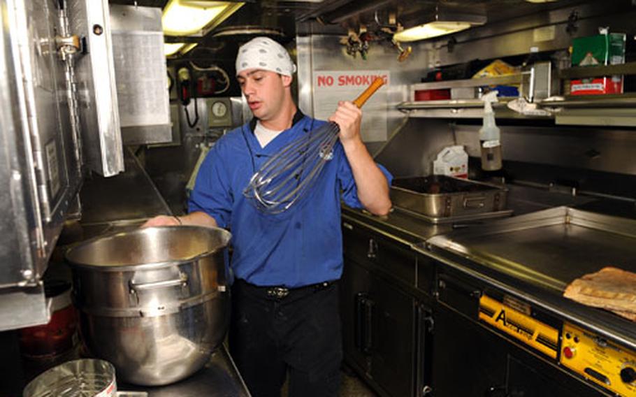 Seaman Timmy Stracner makes mashed potatoes with bacon bits in the galley for the crew of the USS Seawolf. Submarines get larger food budgets than their surface counterparts, and the food is always prepared right before being served.