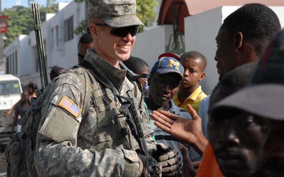 Staff Sgt. James Gresham, Company C, 1st Battalion, 325th Airborne Infantry Regiment, struck up a conversation with a few Haitians outside the main hospital in Port-au-Prince and immediately was surrounded. “I wish I could speak Creole, so I could speak to more of them,” he said.
