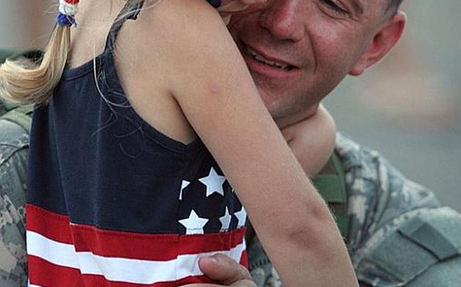 Sgt. 1st Class Kevin Brown, of Morrisville, Vt., hugs his daughter 5-year-old daughter, Lauren, as he and other members of the Vermont National Guard&#39;s Task Force Saber returned home after 11 months in Ramadi, Iraq, Thursday, June 15, 2006, at the National Guard hangar at Burlington International Airport in Burlington, Vt. Six members of the unit were killed during the deployment. 