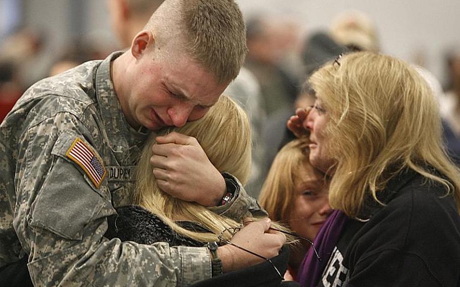 Pfc. Troy Duprey, left, of White River Junction, Vt., hugs his fiance, Tiffany Knapp, as his mother, Gloria, hugs his brother, Josh, before a deployment ceremony in Essex Junction, Vt., Friday, Jan. 8, 2010. Two hundred more Afghanistan-bound troops from the Vermont National Guard are shipping out. They are members of a special training unit of the 86th Infantry Brigade Combat Team based in Rutland. 
