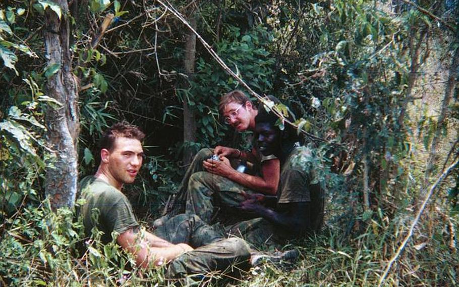 Charles Trumpower (far left) sits in the bush during his 1969 tour of duty with the Marine Corps in Vietnam. He now speaks to veterans across the country about post-traumatic stress disorder.