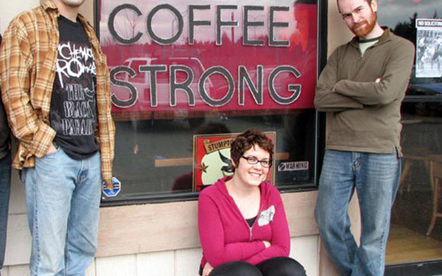 Seth Manzel, left, stands in front of his coffee shop in Tacoma, Wash. The business caters to Afghanistan and Iraq war veterans. To Manzel&#39;s right are Sarah Lazare, who runs a Web site Courage to Resist, and another Coffee Strong worker Michael William.