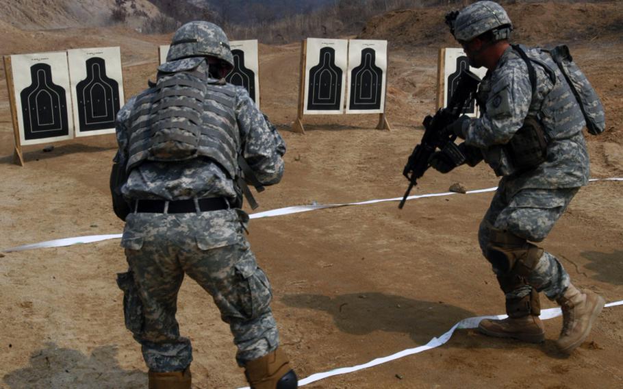 Soldiers with the Hawaii-based 1st Battalion, 27th Infantry Regiment, 25th Infantry Division advance on targets during a live-fire exercise in 2007 at Rodriguez Range in South Korea.  In more recent years, the military has trained troops to reinforce killing as a reflexive behavior. Bull's-eyes were replaced with targets that had human faces and bodies.