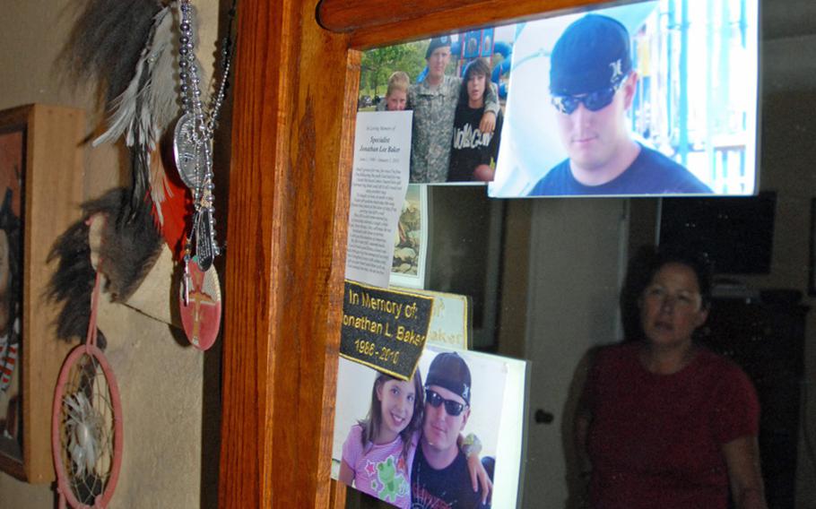 The mirror in Jeanette and John Baker's bedroom is decorated with photos of Spc. Jonathan Hughey. Jeanette occasionally rubs his dog tags, which also hang from the mirror.