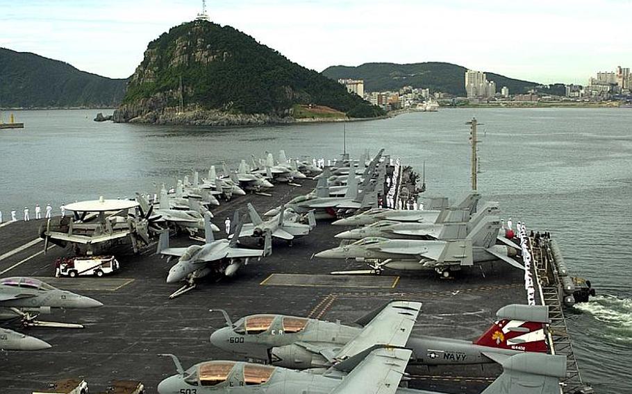 In this file photo, the USS George Washington pulls away from Busan in South Korea in July 2010 on its way to participate in the Invincible Spirit joint military exercise carried out for four days by the U.S. and South Korea. The George Washington operates out of Yokosuka Naval Base, Japan.