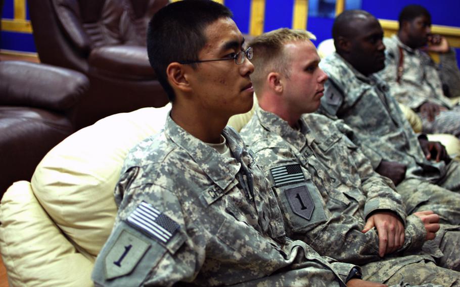 Spc. Yang Chen, a soldier serving in Iraq with the Enhanced Combat Aviation Brigade, 1st Infantry Division, watches a movie in the Taji Warrior Resiliency Campus's theater.