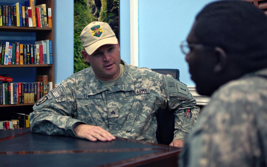 Sgt. David Theis, who works at the Taji Warrior Resiliency Campus on Camp Taji, Iraq, talks with a soldier in the campus's library on Friday. Nearly 2,500 soldiers have used the center since it opened.