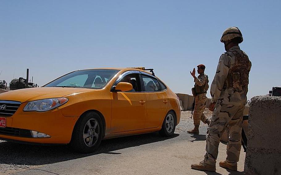 In this undated file photo, soldiers from the Kurdistan Regional Government, the Iraqi army and the U.S. man 22 trilateral checkpoints in the Combined Security Area, disputed lands between the Arabs and the Kurds that cut through 3 provinces in Iraq's northeastern region.