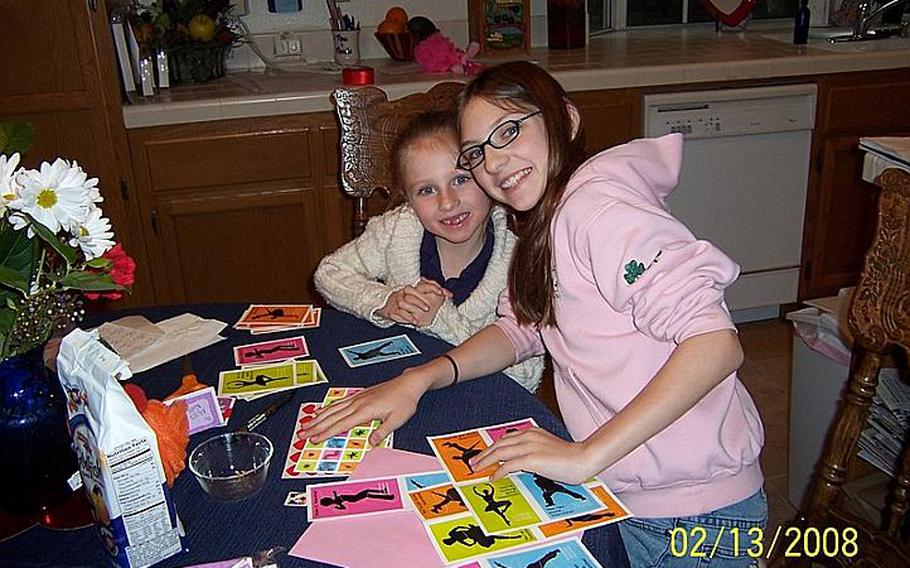 Bailey Caldwell and her sister, Ivie (right) working on homework in the spring of 2008 while living with their grandparents Alan and Debbie Nichols, just outside of Los Angeles. Their mom, then Air Force Tech Sgt. Erin Caldwell, deployed to Afghanistan for four months that year, and the family relied on Erin's parents to care for the girls while the airman was gone. Caldwell has since been promoted to master sergeant.