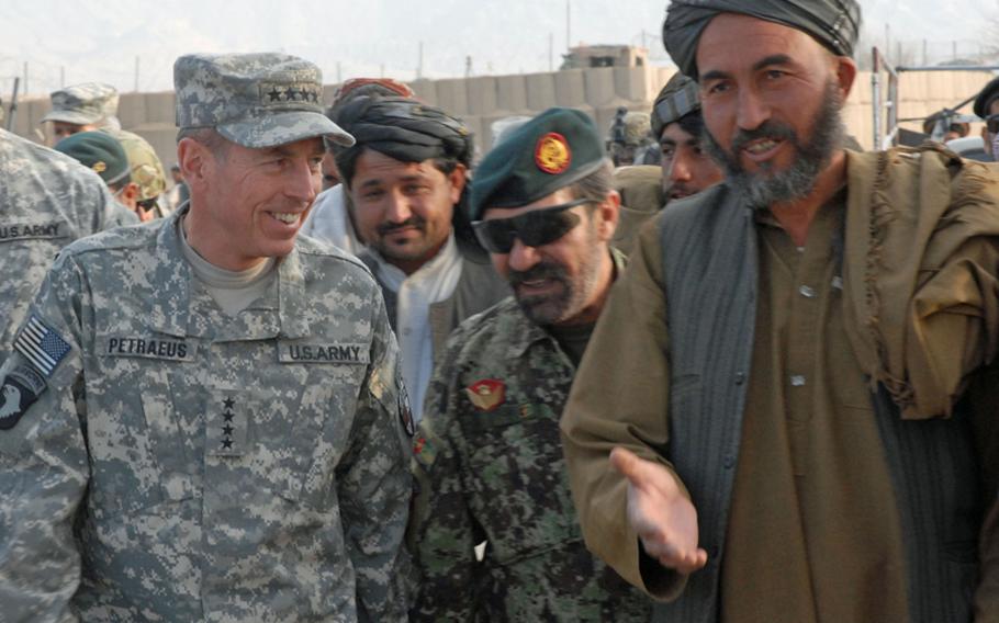 Gen. David Petraeus, commander of the International Security Assistance Force, talks with the elder of a village that had been leveled by the U.S. military in its clearing campaign of the western side of Arghandab district. The Taliban had kicked out the residents of the village, rigged some of the houses to blow and turned the others into homemade bomb factories. The military is now rebuilding the village and there is an outpost nearby.