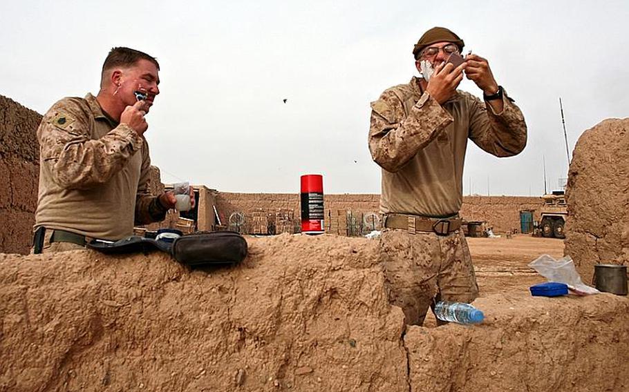 There's no running water at Combat Outpost Coutu, so Staff Sgt. Kevin Barlow, 31, of Richmond, Va., and Lance Cpl. Christopher Bello, 23, of Jacksonville, N.C., shave with just ounces of water each in a plastic water bottle and metal canteen cup. 